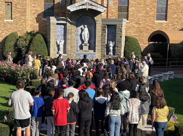 students gathered outdoors at grotto
